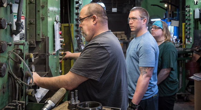 Workers training at Embassy Powdered Metals manufacturing facility