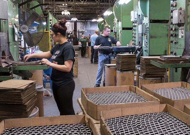 Employees working on manufacturing floor at Embassy Powdered Metals